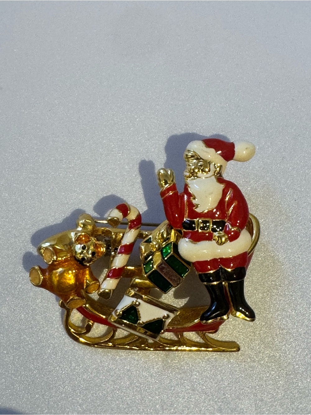 Festive Christmas Santa Sleigh enamel detailed holiday brooch pin.